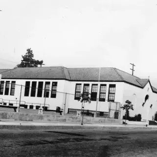 Side view of St. Dominic Catholic Church and school, located on the northeast corner of Ma